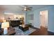 Spacious living room with hardwood floors, leather seating, and open access to the kitchen at 302 Aspen Valley Ln, Dallas, GA 30157