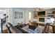 Inviting living room with a brick fireplace, dark hardwood floors, and comfortable leather seating at 302 Aspen Valley Ln, Dallas, GA 30157
