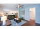 Open concept living room flows to the kitchen and dining area with hardwood floors at 302 Aspen Valley Ln, Dallas, GA 30157
