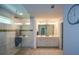 Well-lit bathroom featuring a large glass enclosed shower with a bench seat at 302 Aspen Valley Ln, Dallas, GA 30157