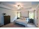 Tranquil bedroom features a tray ceiling, neutral walls, and two windows at 302 Aspen Valley Ln, Dallas, GA 30157