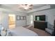 Spacious bedroom with a tray ceiling, tv, and ensuite bathroom at 302 Aspen Valley Ln, Dallas, GA 30157