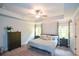 Light-filled main bedroom with tray ceiling, neutral decor, ceiling fan, and carpet at 302 Aspen Valley Ln, Dallas, GA 30157