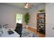 Home office featuring natural light, ceiling fan, and a bookcase for storage at 302 Aspen Valley Ln, Dallas, GA 30157