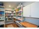 Well-organized walk-in pantry with shelving, cabinets, and ample storage space at 302 Aspen Valley Ln, Dallas, GA 30157
