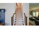 Inviting carpeted staircase with decorative wrought iron spindles and access to the home's living room at 302 Aspen Valley Ln, Dallas, GA 30157