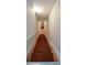 Carpeted staircase leading to a lower level, showcasing a bright, open design at 302 Aspen Valley Ln, Dallas, GA 30157