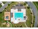Aerial view of a sparkling community pool with lounging areas, play areas, and surrounding landscape at 302 Aspen Valley Ln, Dallas, GA 30157