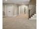 Finished basement featuring carpet flooring, staircase, and access to a bathroom at 400 Mabry Pl, Atlanta, GA 30319