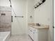 Neutral bathroom featuring a tiled shower with a built-in niche and a vanity with white cabinets at 400 Mabry Pl, Atlanta, GA 30319
