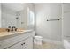 Well-lit bathroom featuring a granite vanity, hexagon tile floor, and combined tub and shower at 400 Mabry Pl, Atlanta, GA 30319