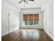Bright bedroom with hardwood floors, tray ceiling, and three large windows with decorative woven shades at 400 Mabry Pl, Atlanta, GA 30319