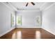 Sunlit, empty bedroom with wood floors, a tray ceiling, and three windows, creating a blank canvas at 400 Mabry Pl, Atlanta, GA 30319