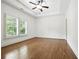 Bright, empty bedroom with tray ceiling, shuttered windows, and wood floors awaiting your personal touch at 400 Mabry Pl, Atlanta, GA 30319