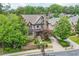 Beautiful exterior view with mature trees, manicured lawn, and a stone chimney feature at 400 Mabry Pl, Atlanta, GA 30319