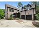 Multi-car garage with an attached two-story brick house at 400 Mabry Pl, Atlanta, GA 30319