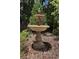 An outdoor tiered stone fountain makes for a relaxing and eye-catching garden feature at 400 Mabry Pl, Atlanta, GA 30319