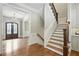 Inviting foyer with hardwood floors, staircase, and a glimpse of the elegant chandelier at 400 Mabry Pl, Atlanta, GA 30319