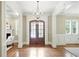 Elegant foyer showcasing beautiful hardwood floors, a stunning chandelier, and natural light at 400 Mabry Pl, Atlanta, GA 30319