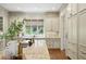 Luxury kitchen island featuring granite countertops, and view of custom cabinetry and hardwood floors at 400 Mabry Pl, Atlanta, GA 30319
