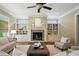 Inviting living room features a stone fireplace, built-in shelving, and a ceiling fan for added comfort at 400 Mabry Pl, Atlanta, GA 30319