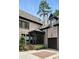 A charming brick home showcasing a covered porch, black trim, an attached garage and a meticulously maintained landscape at 400 Mabry Pl, Atlanta, GA 30319