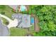 Overhead view of property featuring a pool, well-maintained lawn, and lush trees surrounding the elegant white home at 6017 Chestatee Creek Nw Ct, Acworth, GA 30101