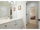 Bright bathroom with white cabinets, modern fixtures, and a view into an adjacent bedroom at 6017 Chestatee Creek Nw Ct, Acworth, GA 30101
