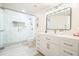 Modern bathroom features a tiled shower with glass enclosure, a vanity with storage and a large mirror at 6017 Chestatee Creek Nw Ct, Acworth, GA 30101