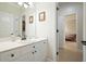 Bathroom with vanity sink, commode, tiled floor, mirror, and natural light at 6017 Chestatee Creek Nw Ct, Acworth, GA 30101