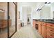 An elegant bathroom features double sinks, granite countertops, and a walk-in shower with a bench at 6017 Chestatee Creek Nw Ct, Acworth, GA 30101