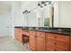 Bathroom featuring dual sinks, granite countertops, and wood cabinetry at 6017 Chestatee Creek Nw Ct, Acworth, GA 30101