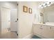 Bright bathroom with a white vanity, ample lighting, and tile flooring at 6017 Chestatee Creek Nw Ct, Acworth, GA 30101