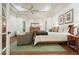 Spacious bedroom featuring hardwood floors, tray ceilings, and a luxurious sitting area at 6017 Chestatee Creek Nw Ct, Acworth, GA 30101