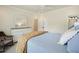Inviting bedroom featuring a white dresser, ceiling fan, rocking chair and comfortable bedding for a restful retreat at 6017 Chestatee Creek Nw Ct, Acworth, GA 30101