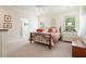 Spacious bedroom features a bed, furniture, neutral colors, and natural light from windows at 6017 Chestatee Creek Nw Ct, Acworth, GA 30101