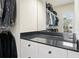 This walk-in closet features white built-in drawers with black countertops and a view to the backyard at 6017 Chestatee Creek Nw Ct, Acworth, GA 30101