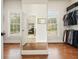 A well-lit walk-in closet features wood flooring, closet organization, and a view to the backyard at 6017 Chestatee Creek Nw Ct, Acworth, GA 30101
