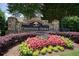 Close up of the Chestatee Creek community sign showcasing colorful flowers and greenery at 6017 Chestatee Creek Nw Ct, Acworth, GA 30101