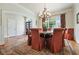 Dining room features a round table, seating for six, chandelier, and bright light from window at 6017 Chestatee Creek Nw Ct, Acworth, GA 30101