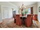 Elegant dining room with a round table, comfortable seating, and wainscoting detail at 6017 Chestatee Creek Nw Ct, Acworth, GA 30101