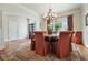 Elegant dining room with large windows, a stylish chandelier, and tastefully coordinated decor for sophisticated entertaining at 6017 Chestatee Creek Nw Ct, Acworth, GA 30101