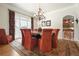 Charming dining room featuring a round table, elegant chandelier, and natural light from large windows at 6017 Chestatee Creek Nw Ct, Acworth, GA 30101