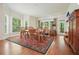 Dining room featuring hardwood floors, large windows, a dining table, and chairs at 6017 Chestatee Creek Nw Ct, Acworth, GA 30101