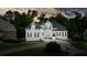 Stately white home with meticulously landscaped front yard, circular drive, and inviting entrance creates a striking curb appeal at 6017 Chestatee Creek Nw Ct, Acworth, GA 30101