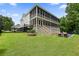 Exterior showcasing the large screened in back porch, inground pool, and fire pit at 6017 Chestatee Creek Nw Ct, Acworth, GA 30101