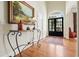 Inviting foyer featuring hardwood floors, a decorative table, and a glimpse of the outdoors through elegant glass doors at 6017 Chestatee Creek Nw Ct, Acworth, GA 30101