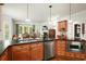 Open kitchen featuring granite countertops, stainless steel appliances, and seamless view to the dining room at 6017 Chestatee Creek Nw Ct, Acworth, GA 30101