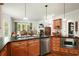 Wood kitchen cabinets with stainless steel appliances and granite countertops at 6017 Chestatee Creek Nw Ct, Acworth, GA 30101