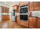 Modern stainless appliances and wood cabinets in an open kitchen at 6017 Chestatee Creek Nw Ct, Acworth, GA 30101